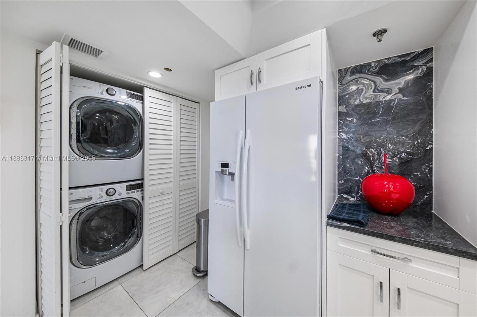 520 Brickell Key Drive, Unit A710 Miami, FL 33131 - Photo 25 of 43 a view of a storage and utility room with washer and dryer