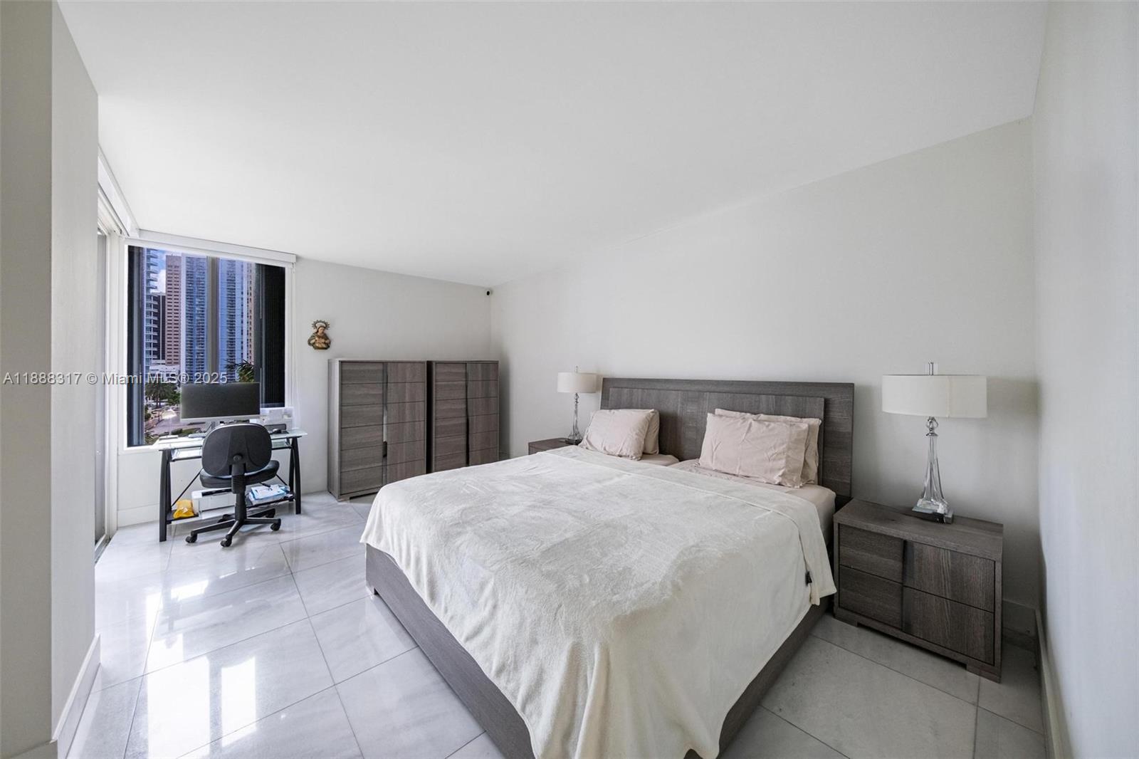520 Brickell Key Drive, Unit A710 Miami, FL 33131 - Photo 5 of 43 a large bedroom with a bed and furniture