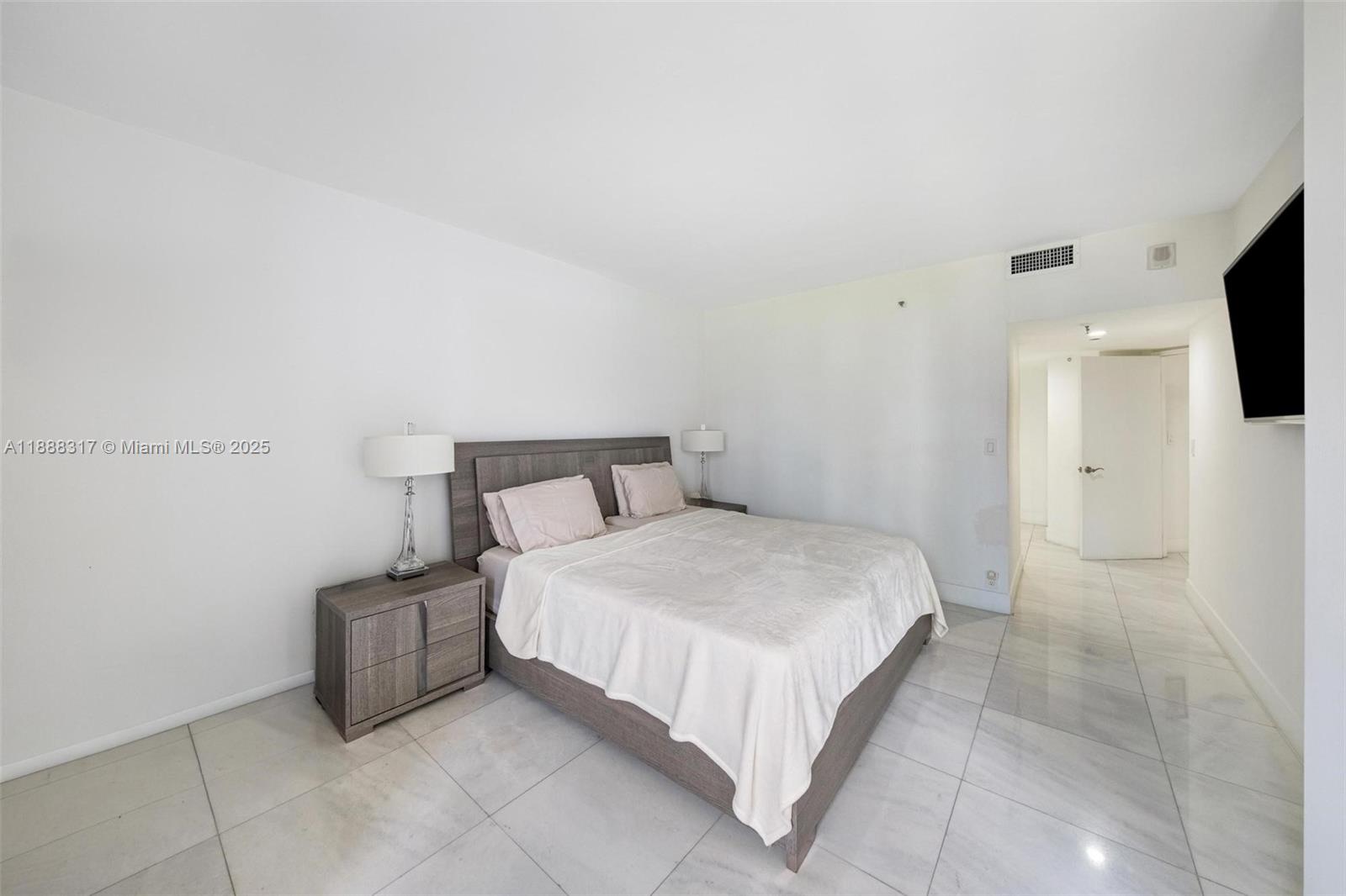 520 Brickell Key Drive, Unit A710 Miami, FL 33131 - Photo 7 of 43 a bedroom with a bed and a flat screen tv