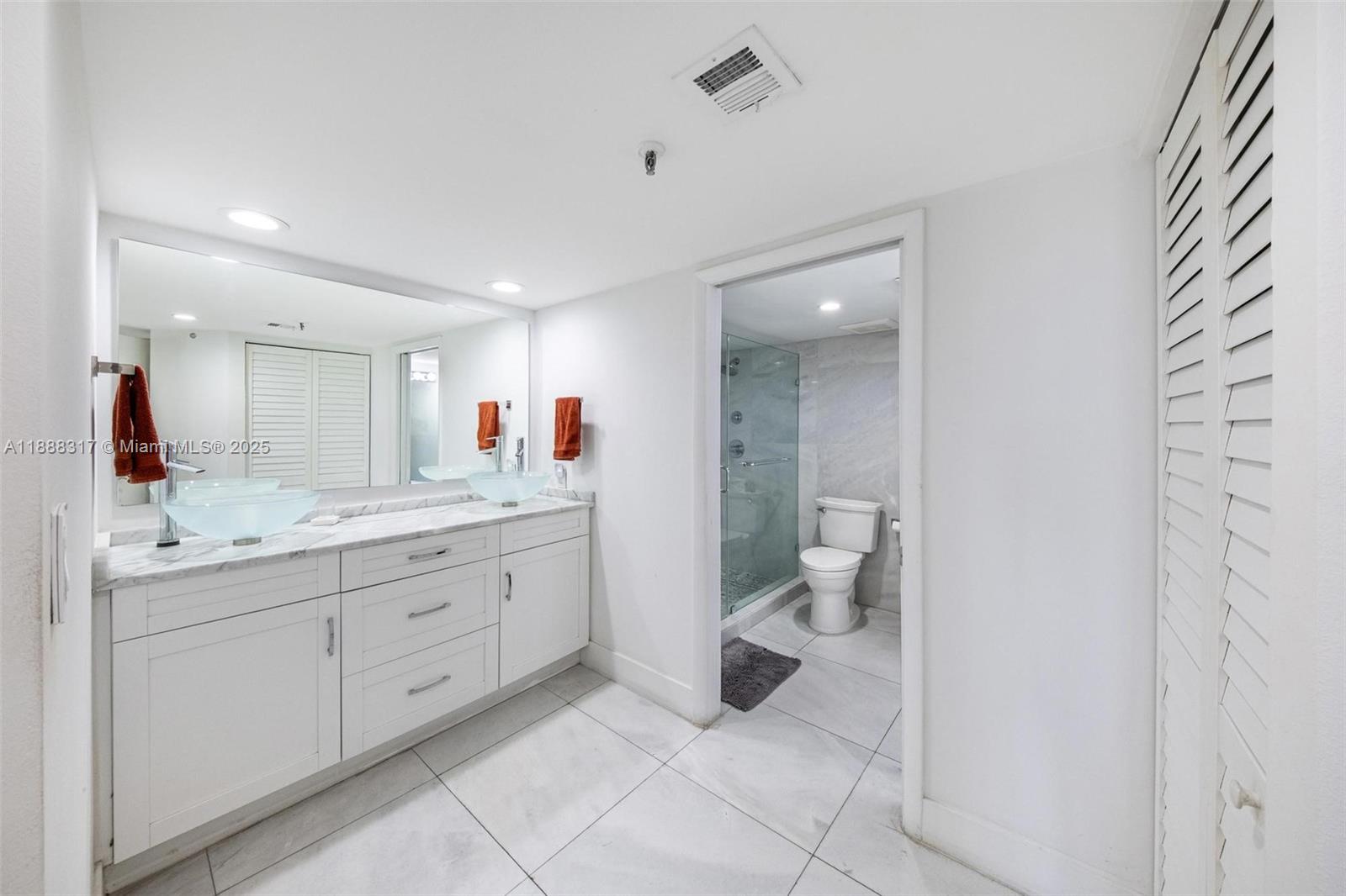520 Brickell Key Drive, Unit A710 Miami, FL 33131 - Photo 9 of 43 a bathroom with a granite countertop sink mirror and toilet