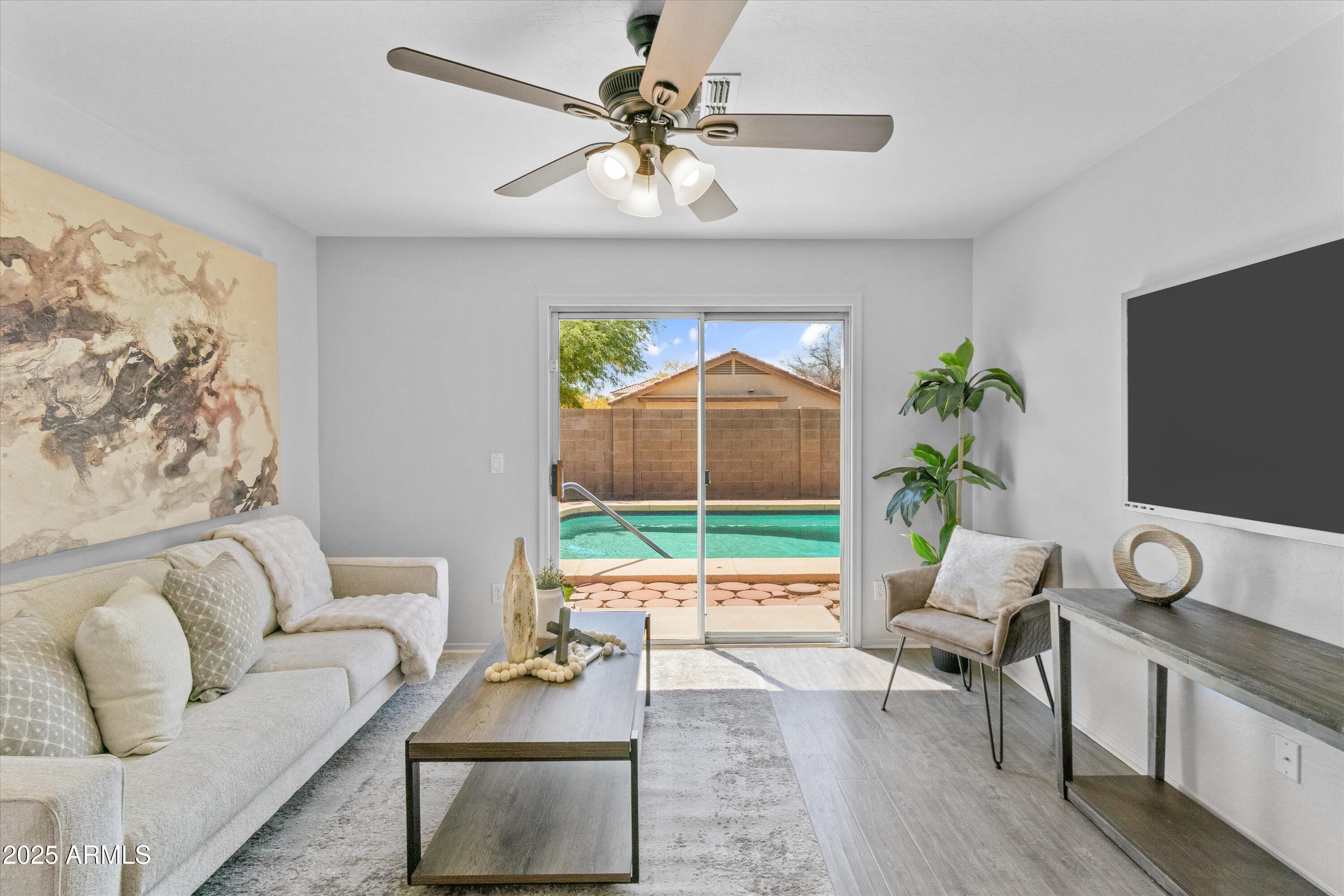 11921 West Bloomfield Road El Mirage, AZ 85335 - Photo 11 of 24 a living room with furniture a rug and a flat screen tv