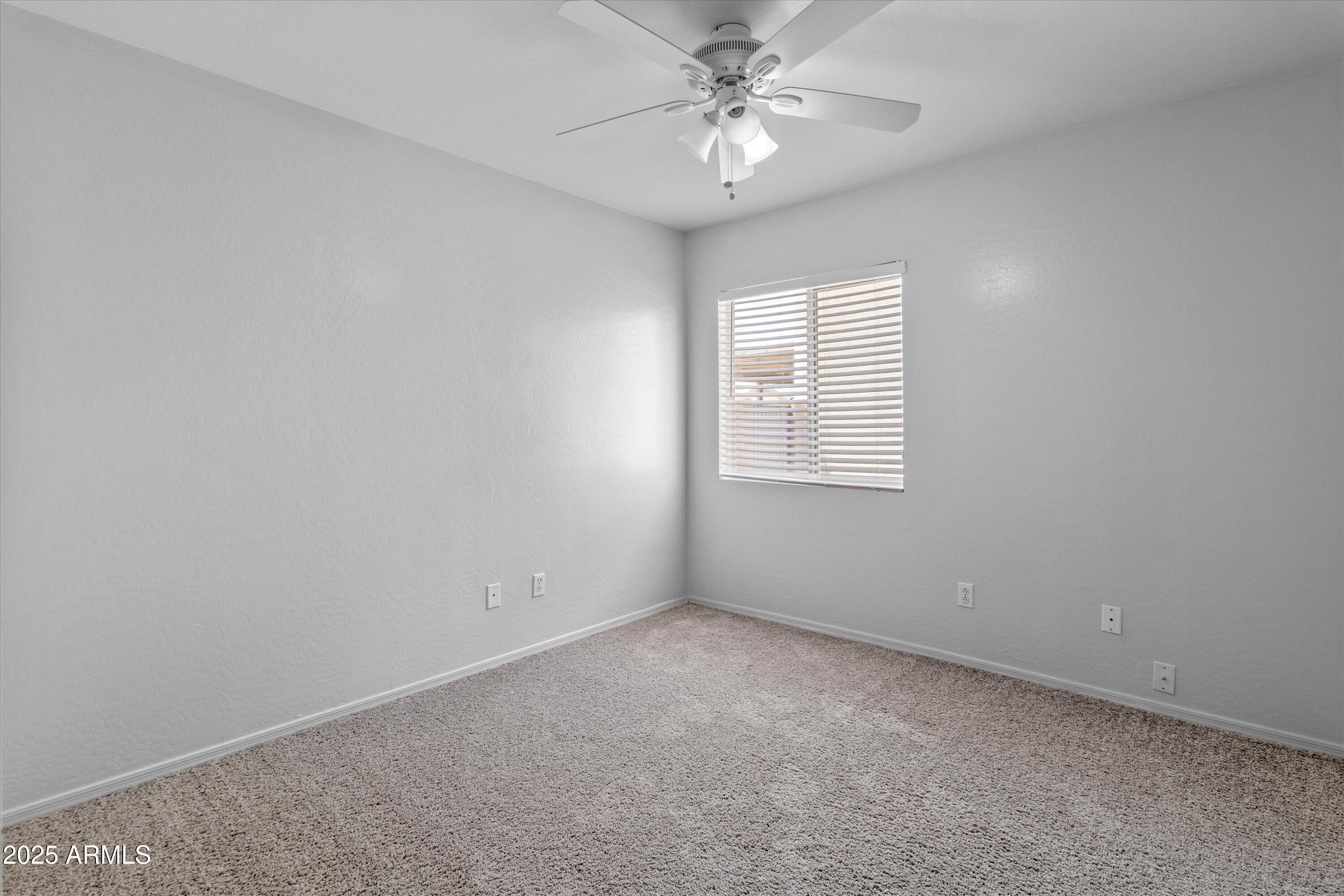 11921 West Bloomfield Road El Mirage, AZ 85335 - Photo 16 of 24 an empty room with windows and fan