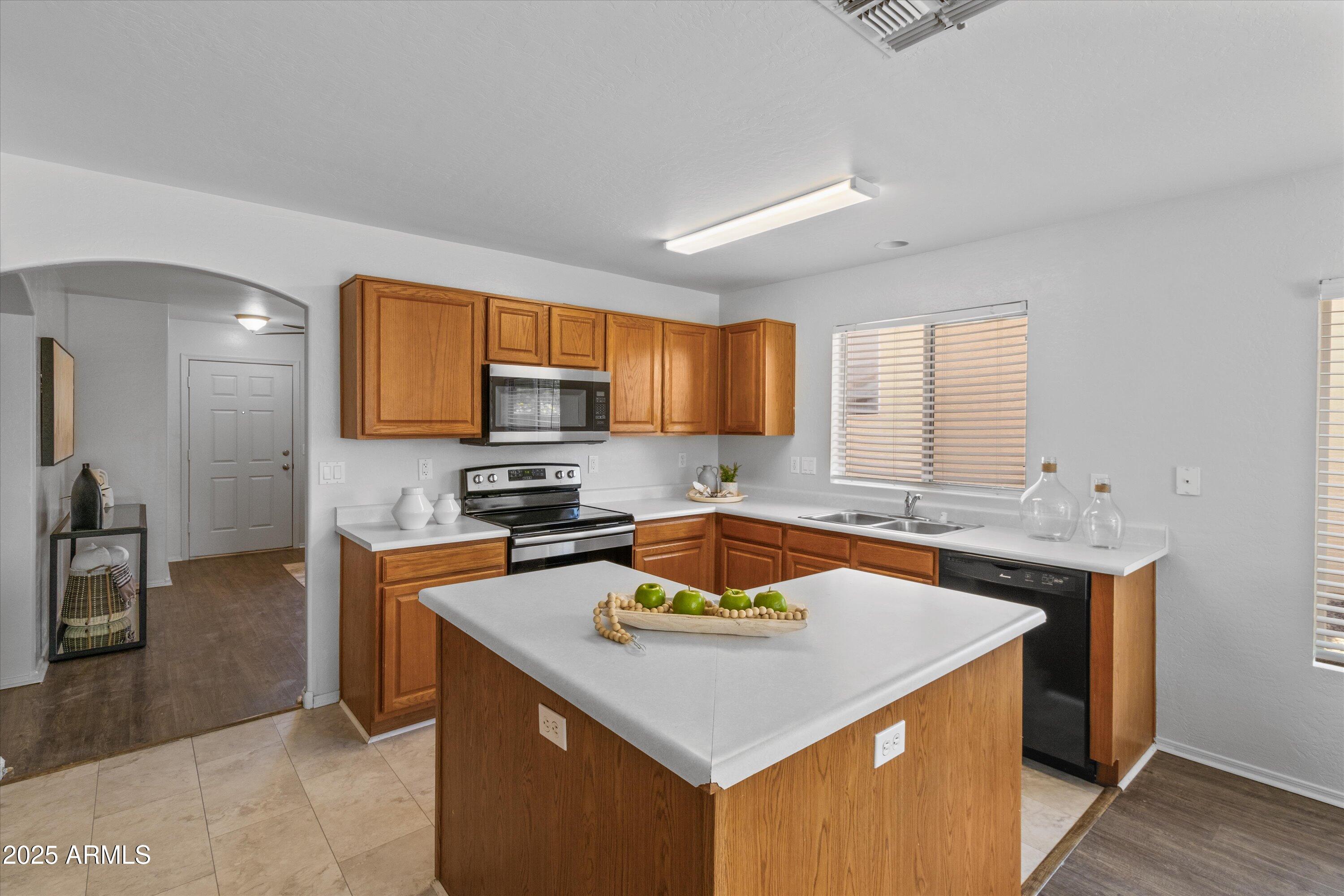 11921 West Bloomfield Road El Mirage, AZ 85335 - Photo 7 of 24 a kitchen with stainless steel appliances granite countertop a sink stove and refrigerator
