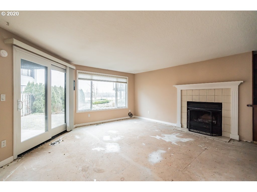 5620 Southwest Riverside Lane Portland, OR 97239 - Photo 13 of 25 a view of an empty room with a fireplace and a window