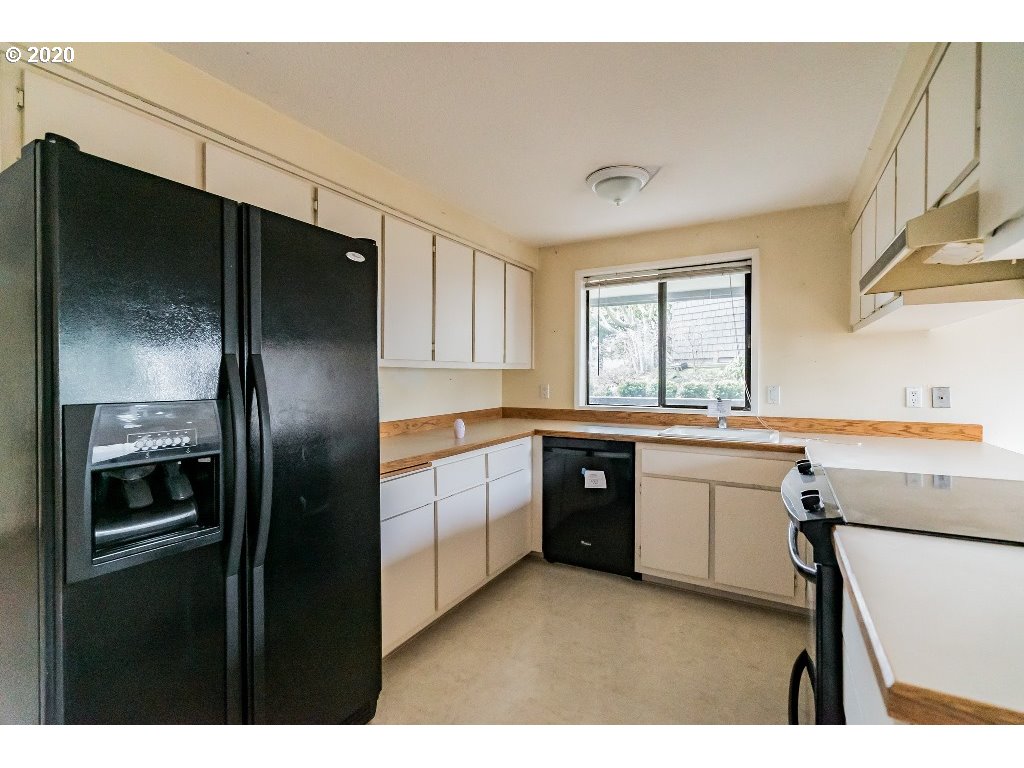 5620 Southwest Riverside Lane Portland, OR 97239 - Photo 20 of 25 a kitchen with a refrigerator sink and stove