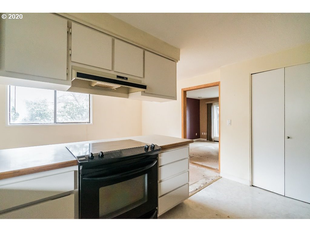 5620 Southwest Riverside Lane Portland, OR 97239 - Photo 23 of 25 a kitchen with granite countertop a sink cabinets and wooden floor