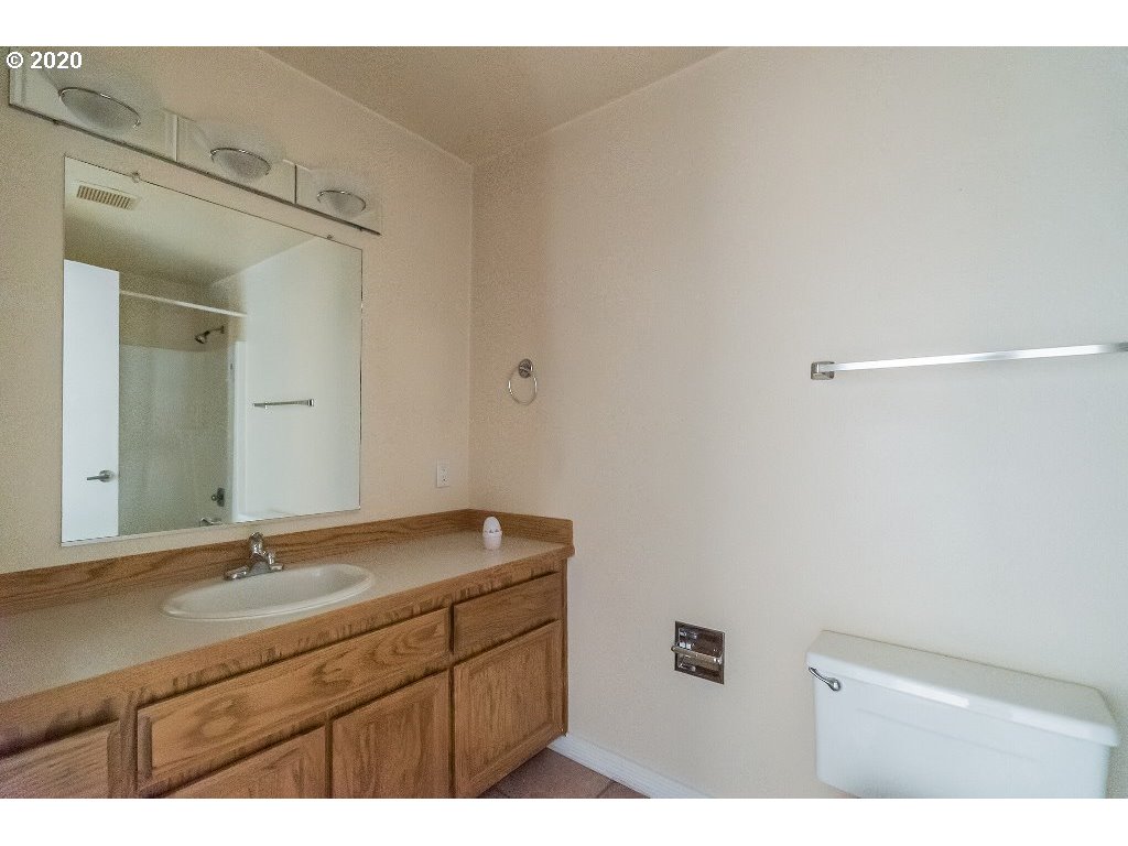 5620 Southwest Riverside Lane Portland, OR 97239 - Photo 25 of 25 a bathroom with a sink and a mirror