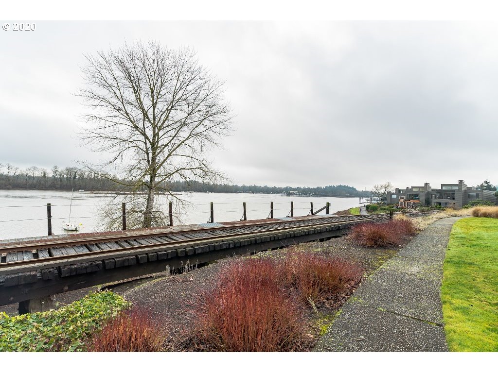 5620 Southwest Riverside Lane Portland, OR 97239 - Photo 3 of 25 a view of a lake with houses in the back
