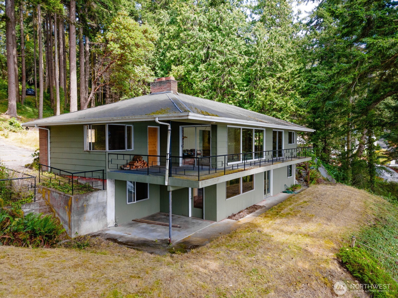 5318 Quiet Cove Road Anacortes, WA 98221 - Photo 11 of 32 a house with trees in the background