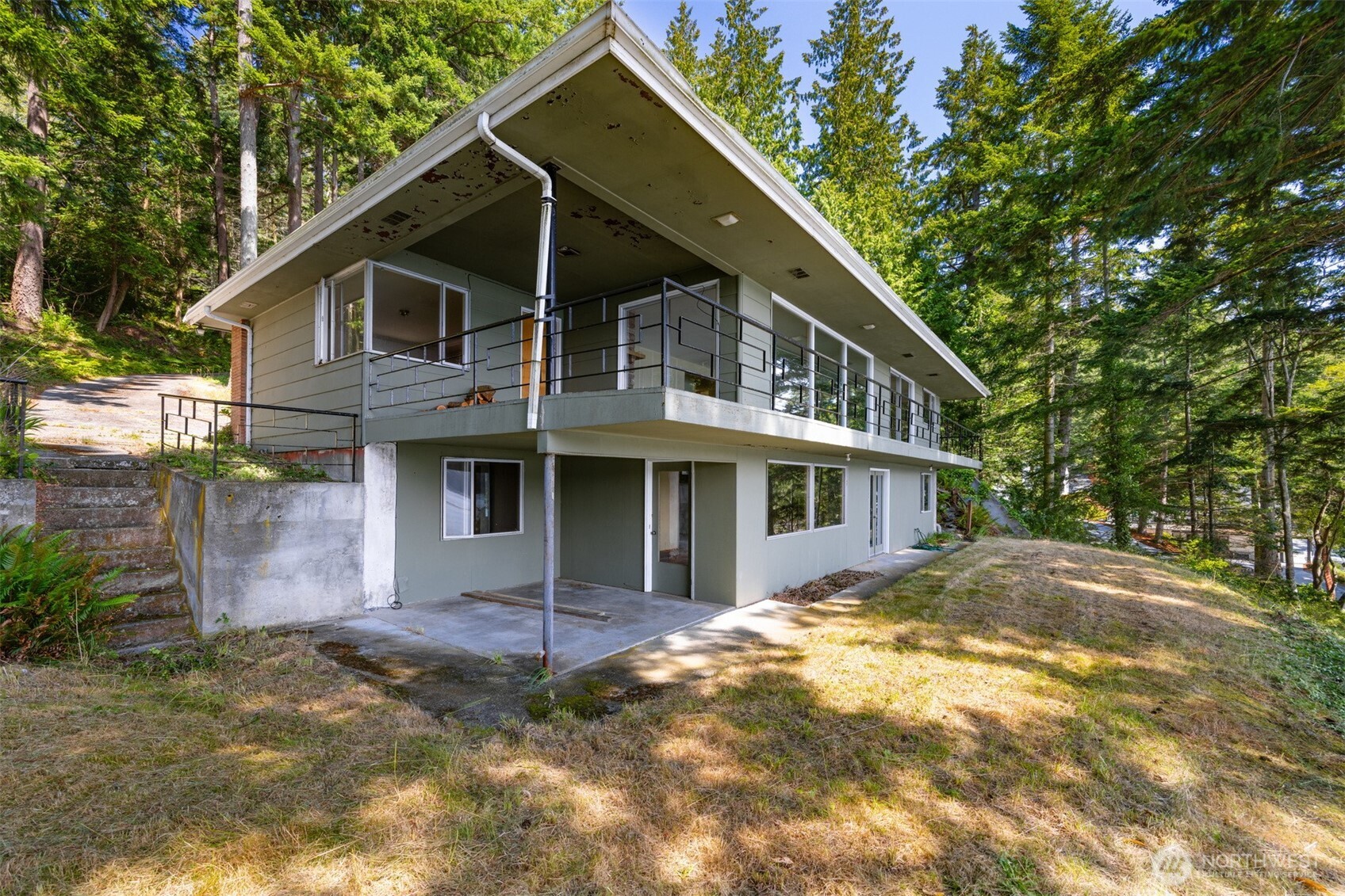 5318 Quiet Cove Road Anacortes, WA 98221 - Photo 12 of 32 a front view of a house with a yard