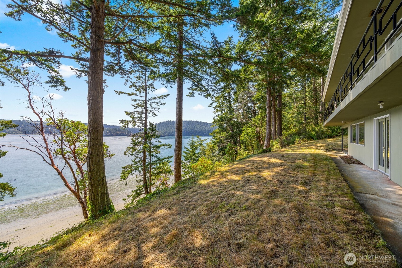 5318 Quiet Cove Road Anacortes, WA 98221 - Photo 17 of 32 a view of a yard with plants and trees