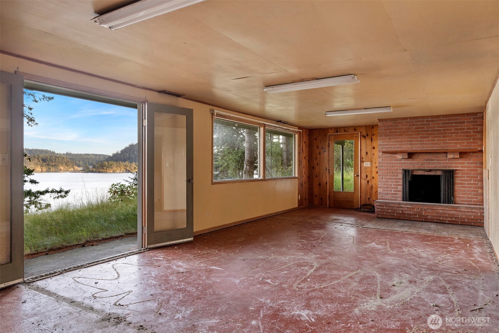 5318 Quiet Cove Road Anacortes, WA 98221 - Photo 30 of 32 wooden floor in an empty room with a fireplace