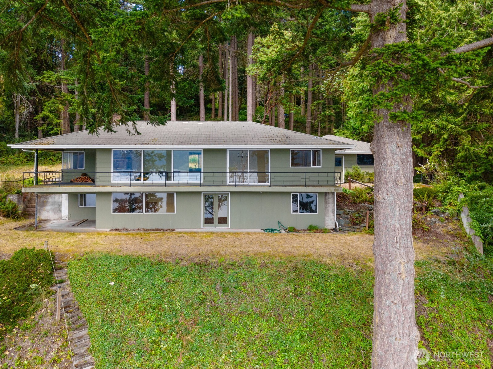5318 Quiet Cove Road Anacortes, WA 98221 - Photo 9 of 32 a front view of a house with a yard