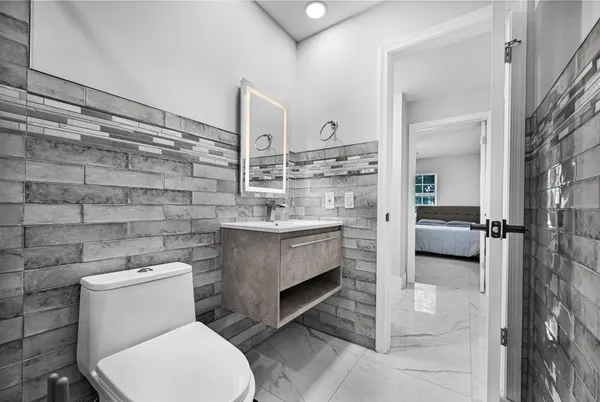 a bedroom with two beds and painting on the wall