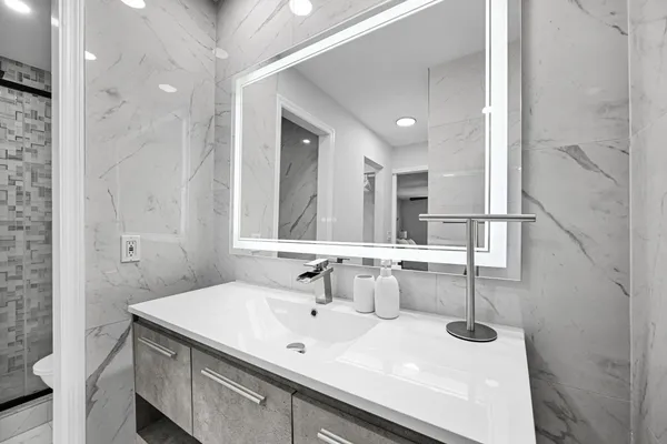 a bedroom with two separate beds and painting on the wall