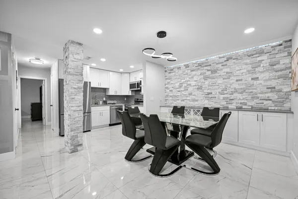 a living room with furniture a rug and white walls