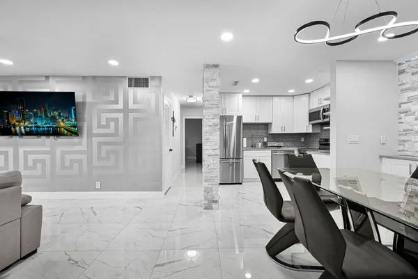 a view of a patio with table and chairs plants and palm trees