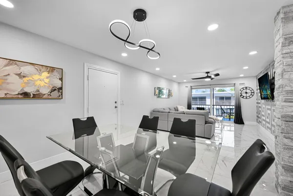 a kitchen with stainless steel appliances granite countertop a refrigerator a stove a sink and a microwave