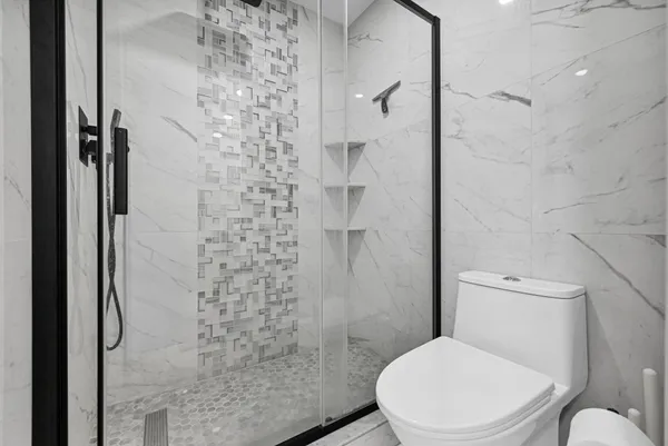 a bedroom with a bed and a flat tv screen on the dresser