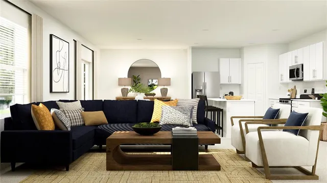 a living room with furniture fireplace and a large window