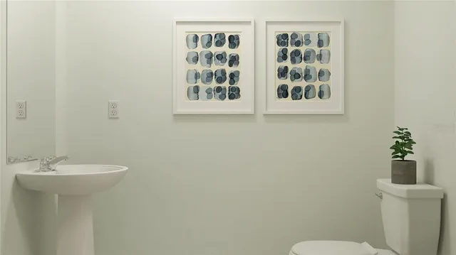 a bathroom with a sink mirror and toilet