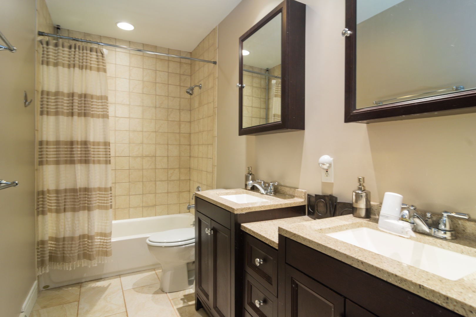 1122 Kenton Road Deerfield, IL 60015 - Photo 7 of 10 a bathroom with a double vanity sink toilet and shower