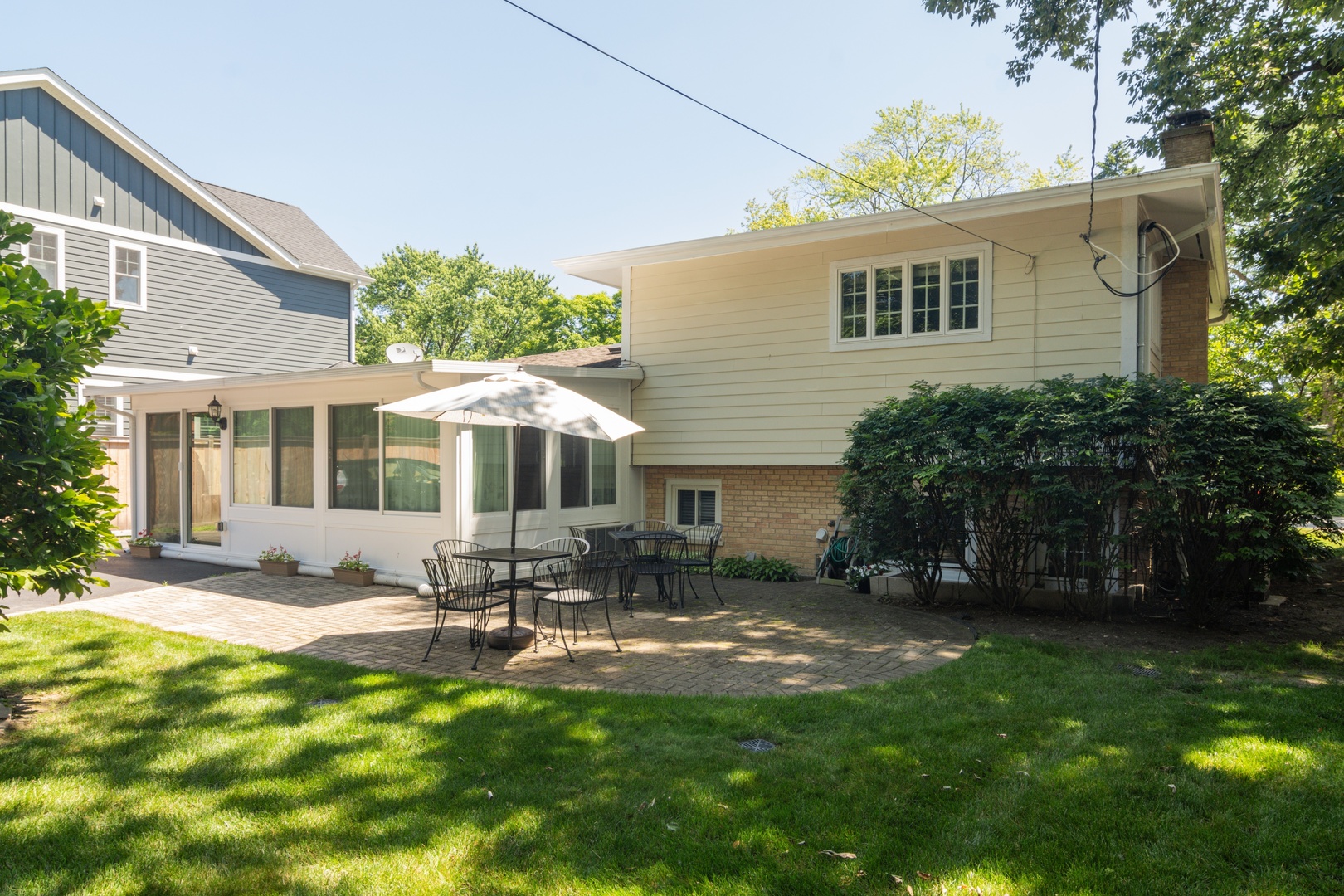1122 Kenton Road Deerfield, IL 60015 - Photo 10 of 10 a view of a house with backyard sitting area and garden