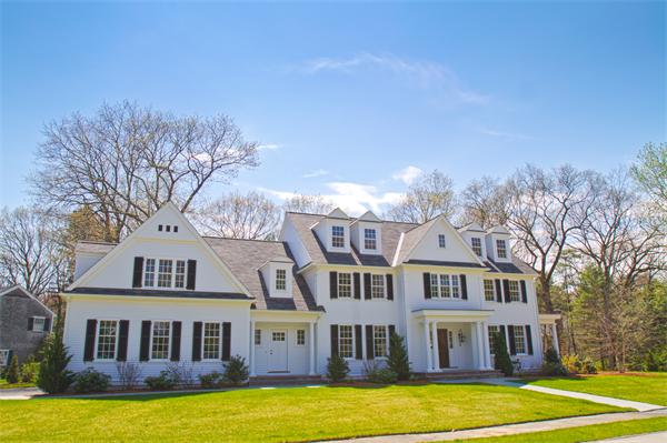 29 Cornell Road Wellesley, MA 02482 - Photo 22 of 23 a front view of residential houses with yard and trees in the background