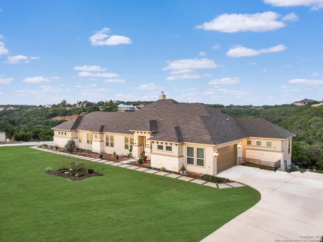 a aerial view of residential houses with yard and mountain view in back