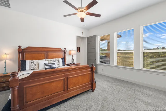 a bed sitting in a bedroom next to a window