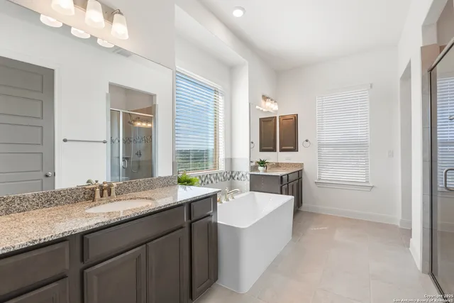 a bathroom with a sink double vanity granite and a mirror