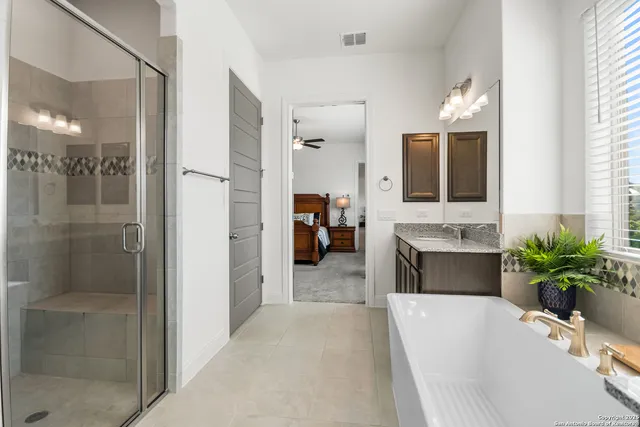 a en suite bathroom with a tub shower and sink