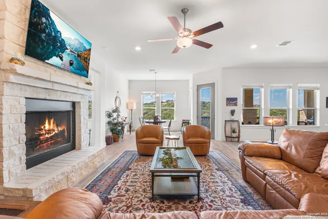 a living room with furniture a fireplace and a flat screen tv