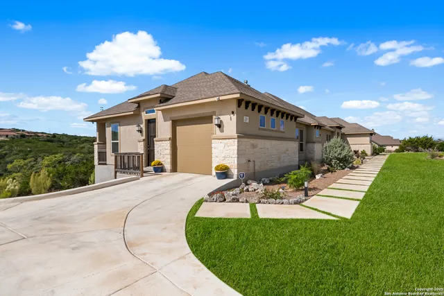 a view of a house with a big yard and a garden