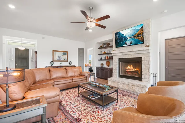 a living room with furniture and a fireplace