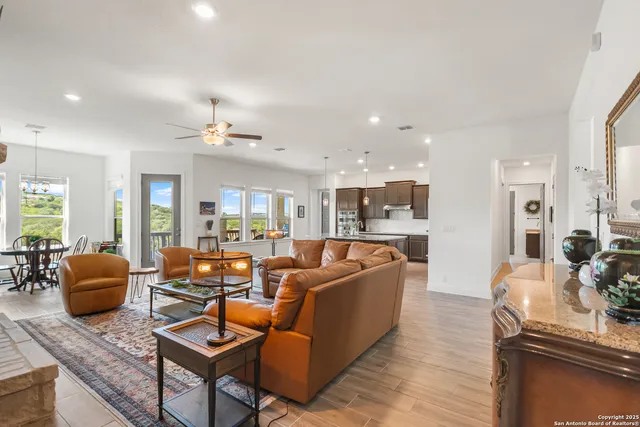 a living room with fireplace furniture and a table