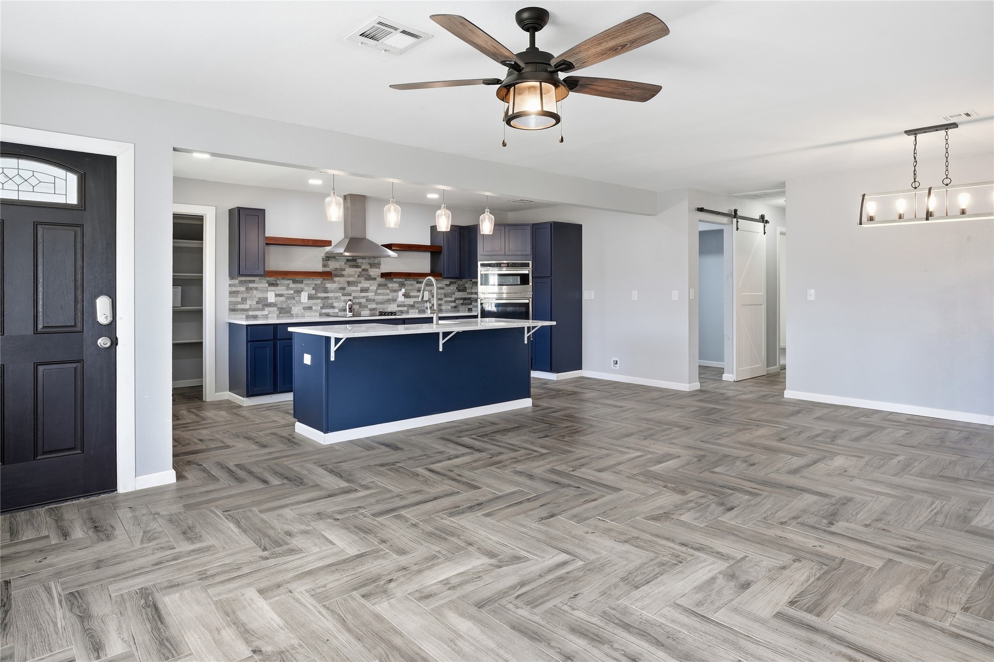81232 South 4775 Road Stilwell, OK 74960 - Photo 20 of 50 Herringbone wood-finish flooring, recessed lighting, and a contemporary ceiling fan