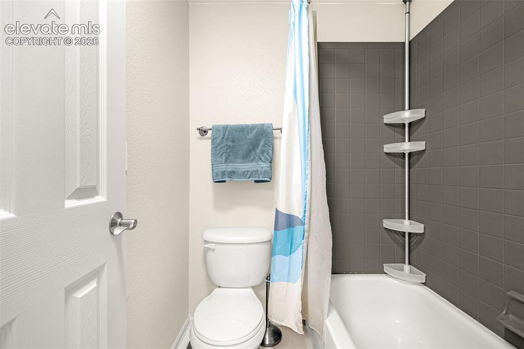 9127 Oakmont Road Peyton, CO 80831 - Photo 30 of 49 a white toilet sitting next to a bathroom sink
