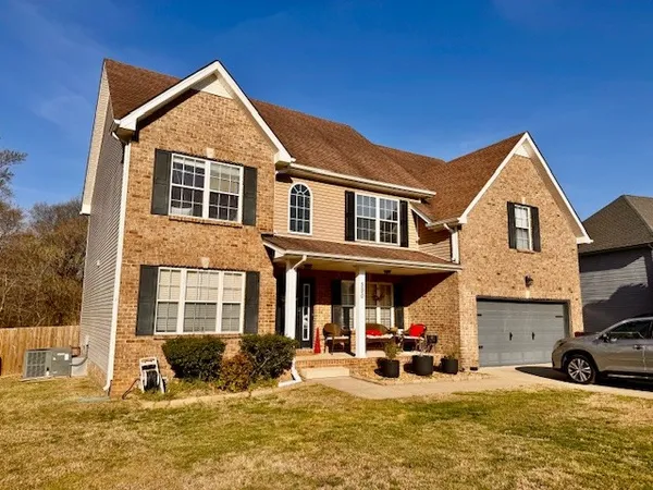 a view of a house with large windows and a small yard