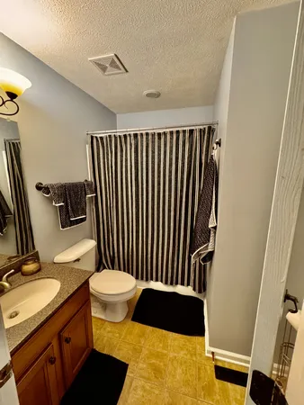 a bed room with a bed and a chair
