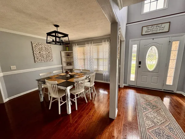 a dining room with furniture and wooden floor