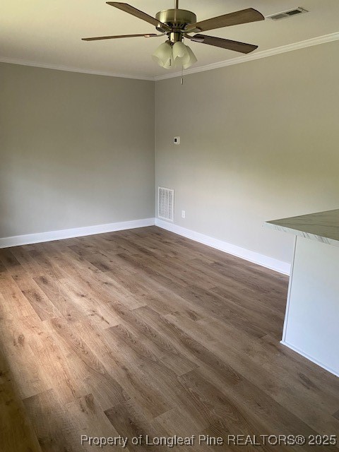 217 Bethune Street, Unit B Fayetteville, NC 28305 - Photo 4 of 13 en empty room with wooden floor and fan