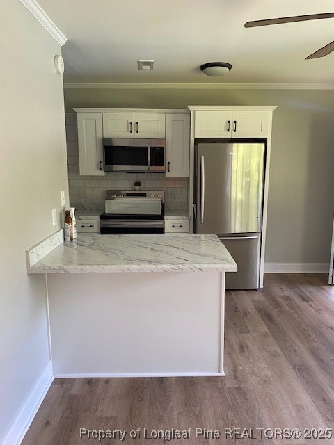 217 Bethune Street, Unit B Fayetteville, NC 28305 - Photo 5 of 13 a kitchen with stainless steel appliances a refrigerator and a sink