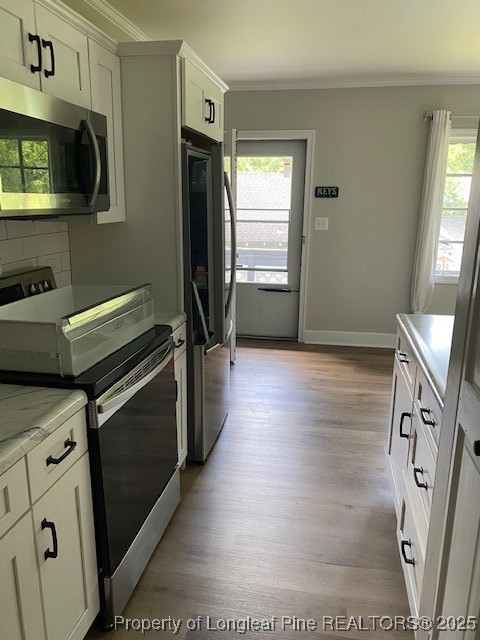217 Bethune Street, Unit B Fayetteville, NC 28305 - Photo 6 of 13 a kitchen with stainless steel appliances a stove microwave and refrigerator