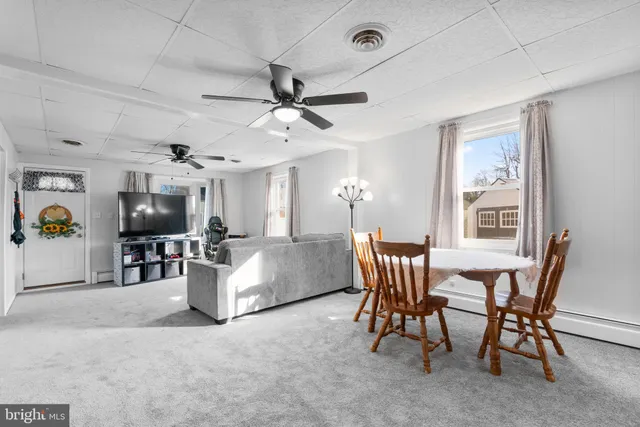 a living room with furniture and flat screen tv