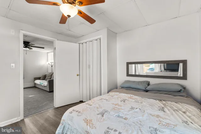 a bedroom with furniture and a flat screen tv