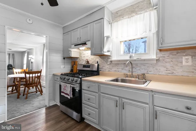 a kitchen with stainless steel appliances granite countertop a refrigerator and a stove