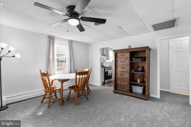 a view of a dining room with furniture and a flat screen tv