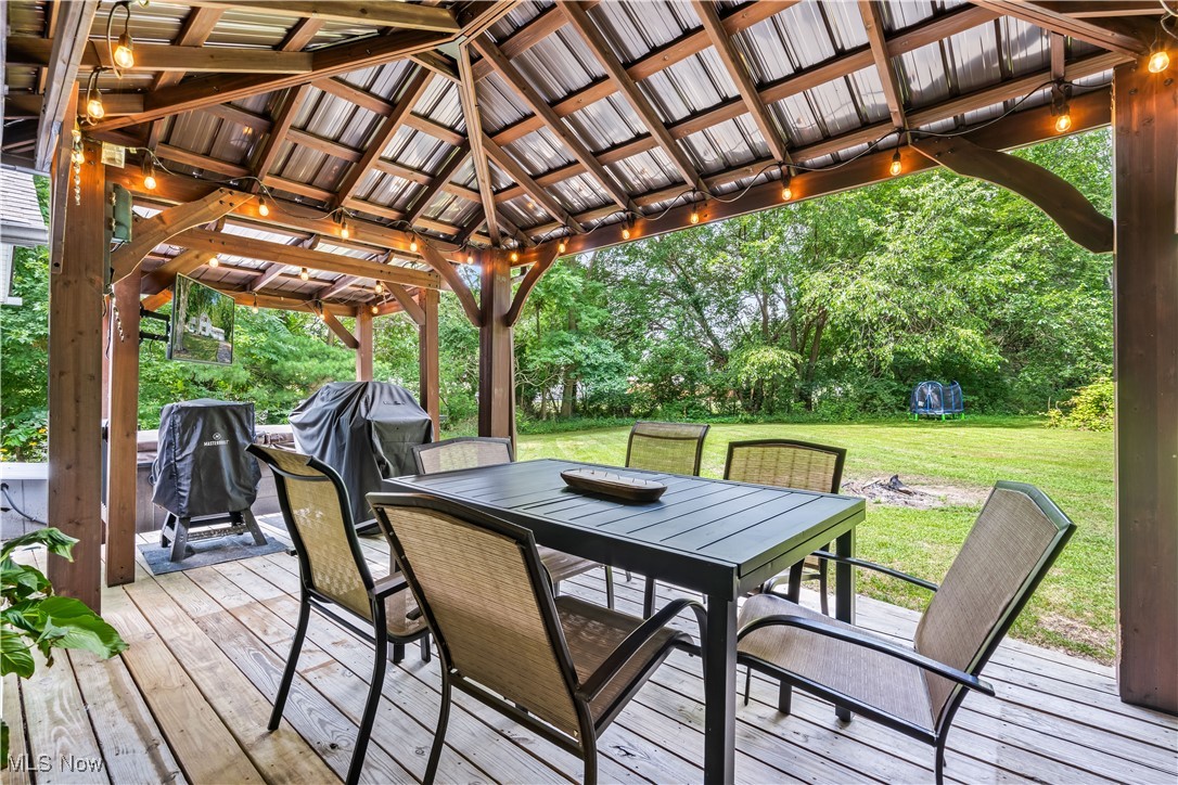 6170 Oberlin Road Amherst, OH 44001 - Photo 13 of 39 Wooden terrace with outdoor dining area, a gazebo, a yard, and area for grilling