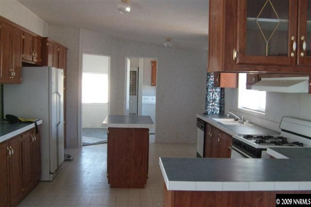 3840 Hummingbird Drive Reno, NV 89508 - Photo 2 of 9 a kitchen with stainless steel appliances granite countertop a sink stove and refrigerator